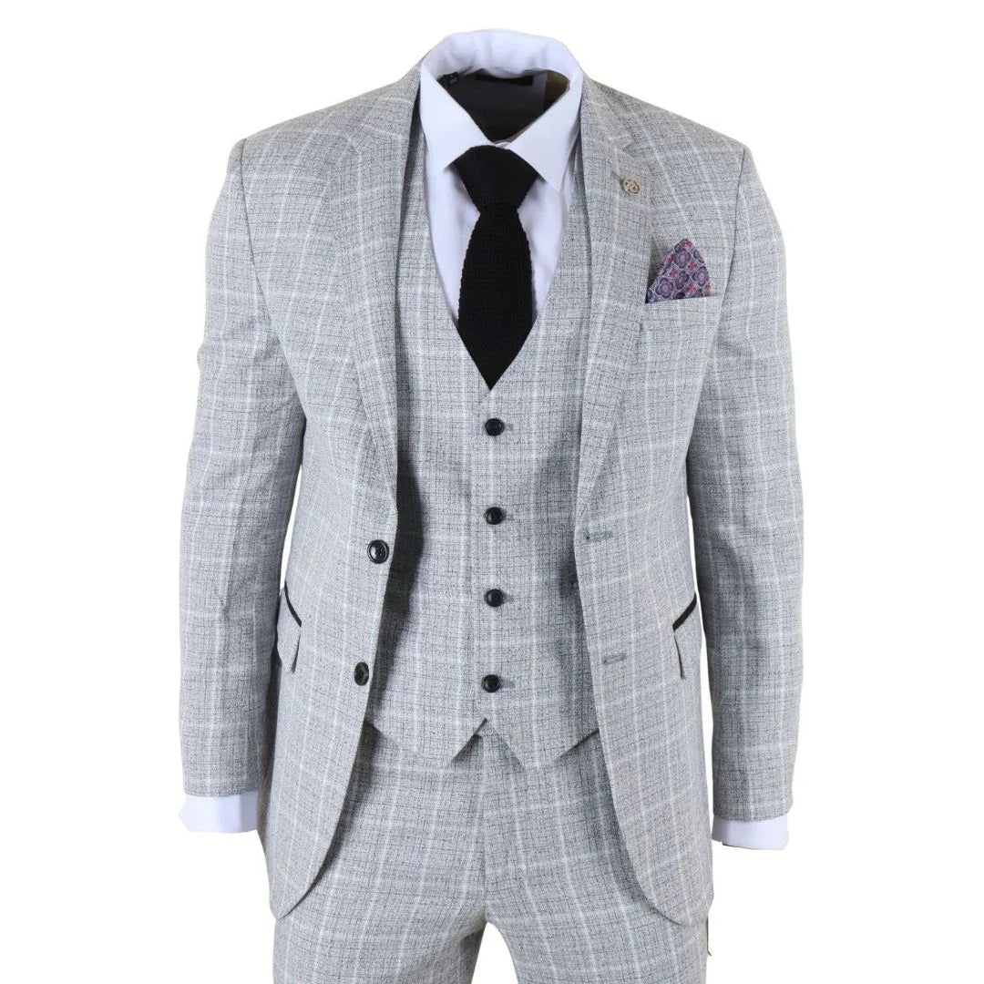 Gray checkered suit with a black tie and purple pocket square on a white background